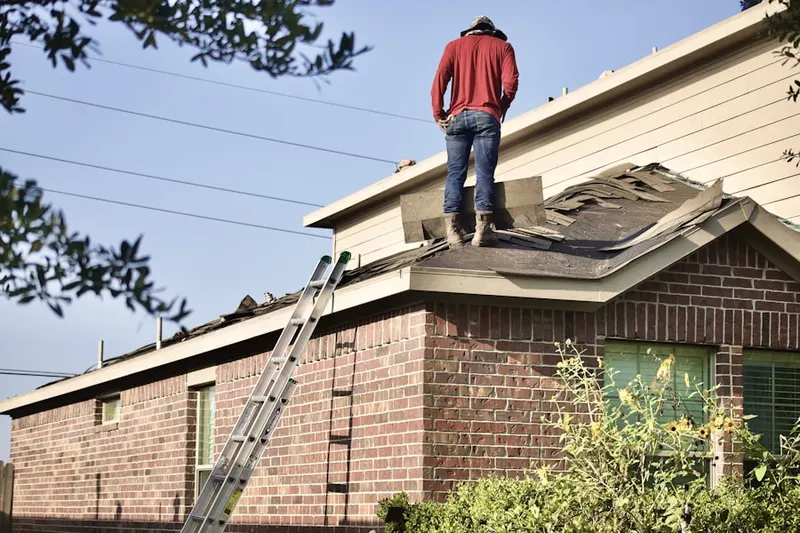 Professional roofer working on a residential roof in Virts Corner